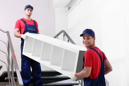 Professional movers handling furniture during a local house move