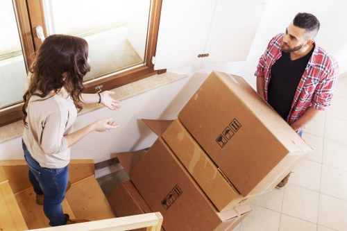 Boxes and furniture prepared for collection by a moving team
