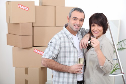 Professional man and van team handling boxes and furniture in Norwood Green